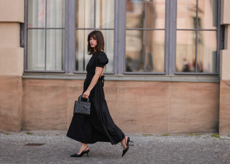BERLIN, GERMANY - MAY 31: Lea Naumann wearing Prada black heels, black midi dress, Dior black Lady bag on May 31, 2022 in Berlin, Germany. (Photo by Jeremy Moeller/Getty Images)