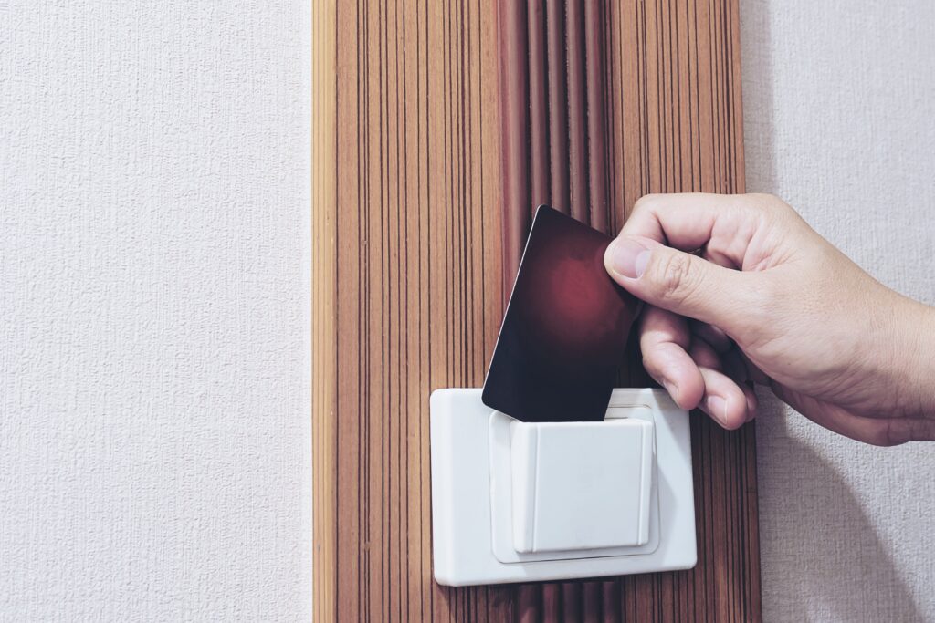 man putting key card switch hotel room