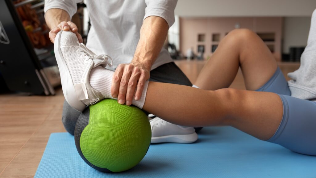 patient doing physical rehabilitation helped by therapists