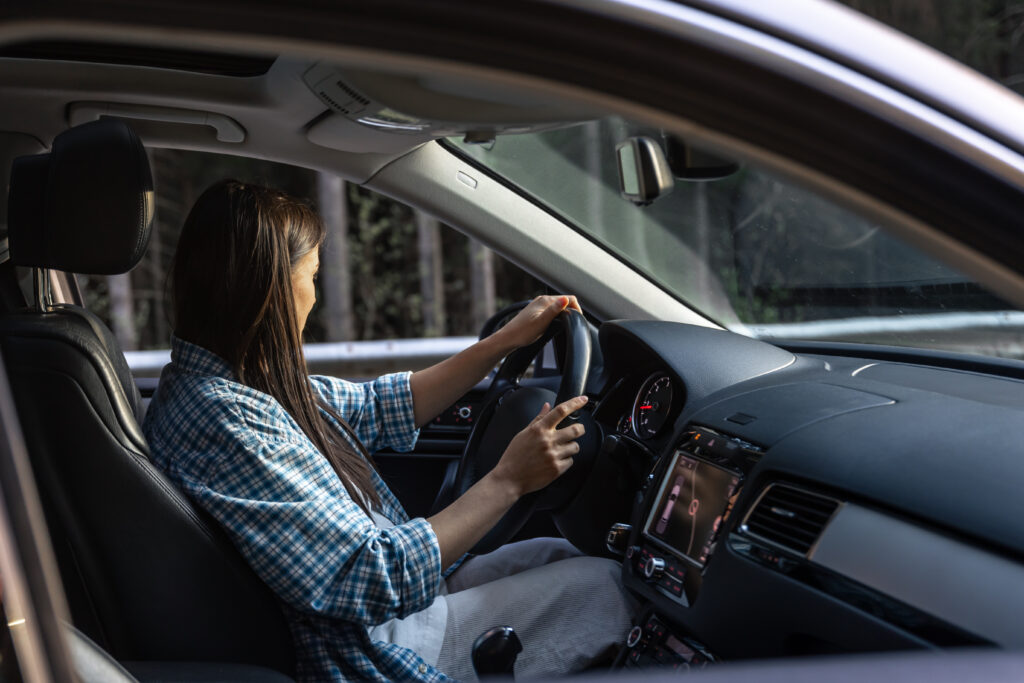 woman driving car forest mountain travel concept