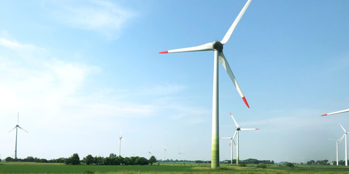 scenery wind turbines middle field clear sky