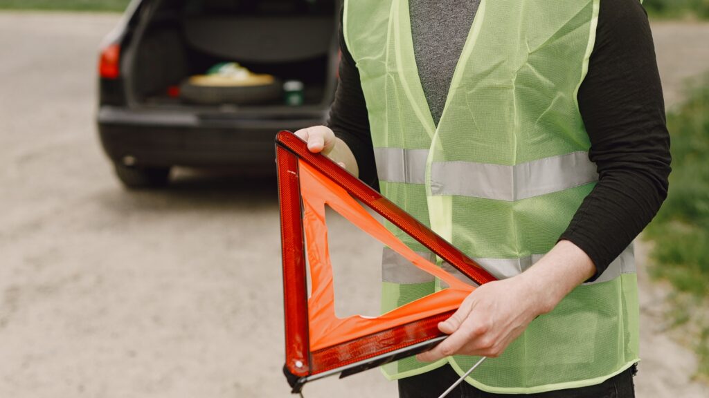 car with problems red triangle warn other road users