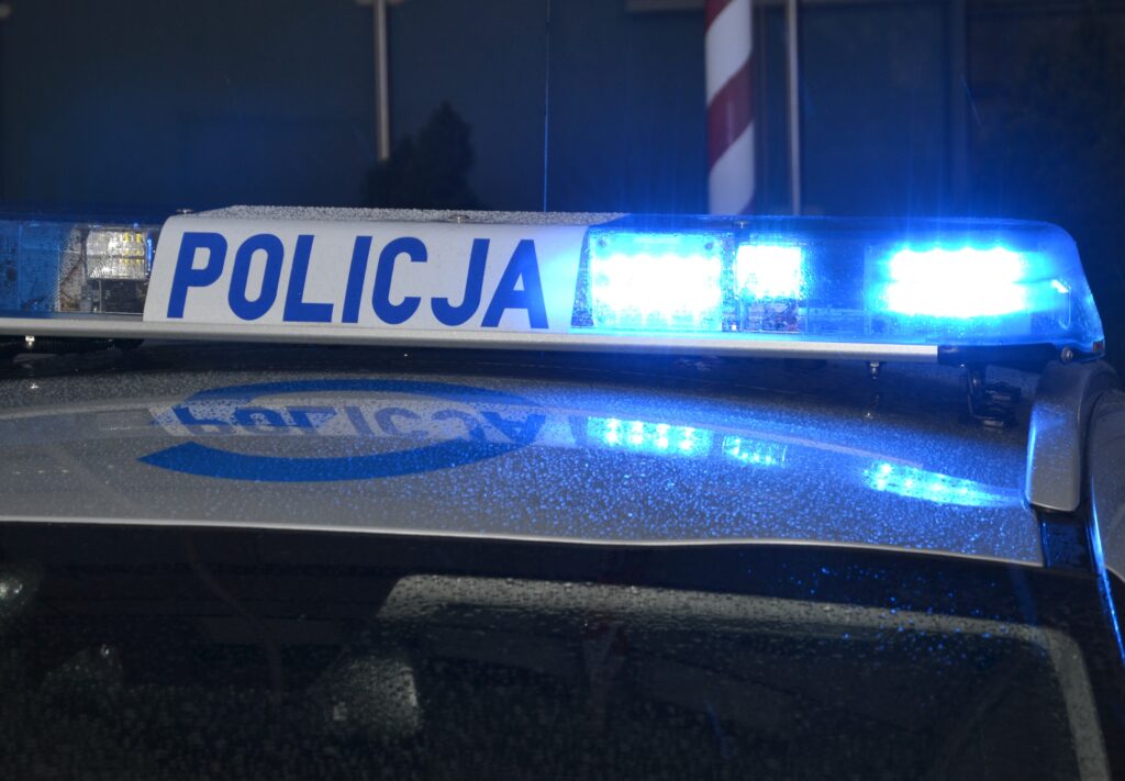 noc fragment dachu radiowozu z wlaczona lampa blyskowa